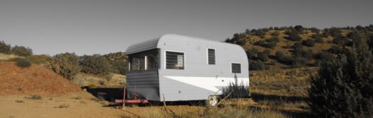 A caravan in the middle of sand dunes.