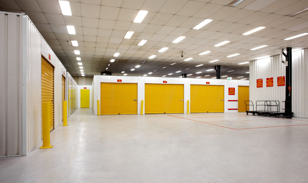 Inside storage units, with yellow roller doors
