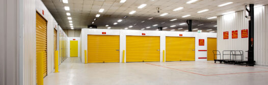 Inside storage units, with yellow roller doors
